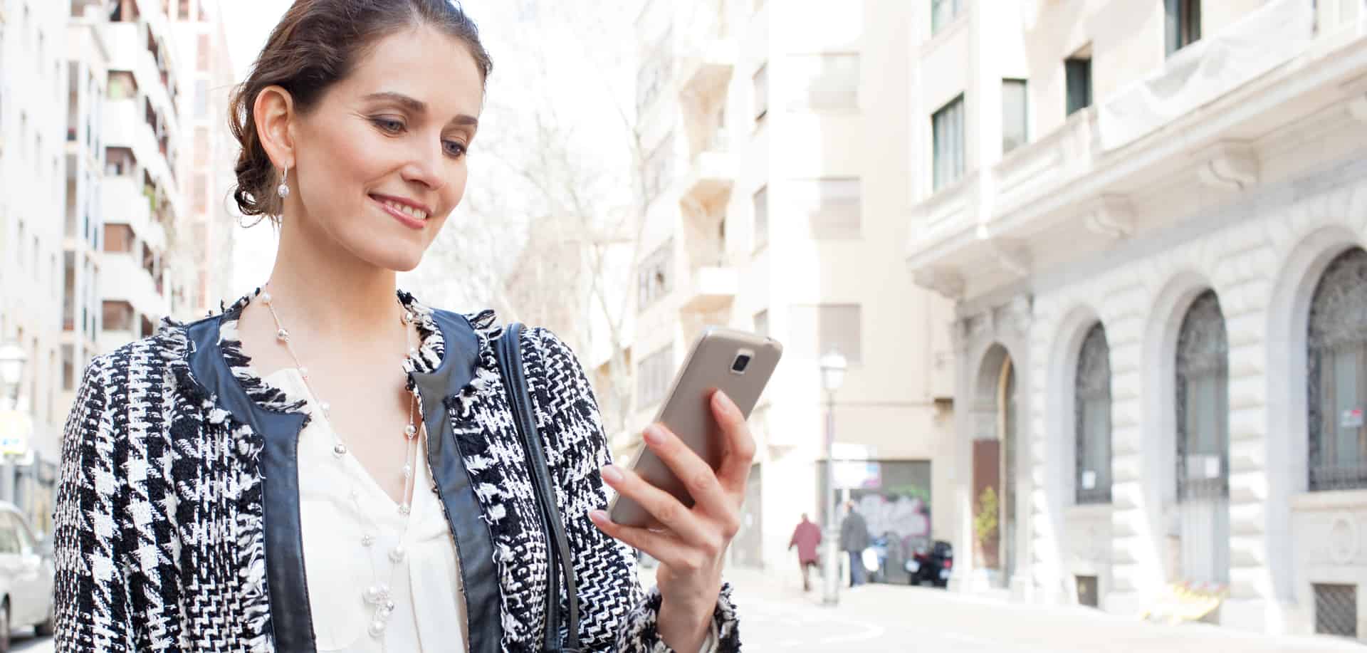 A businesswoman looks at her SMS audit on her smartphone